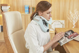 Woman using a neck pillow in an office