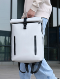 holding a white backpack with black straps